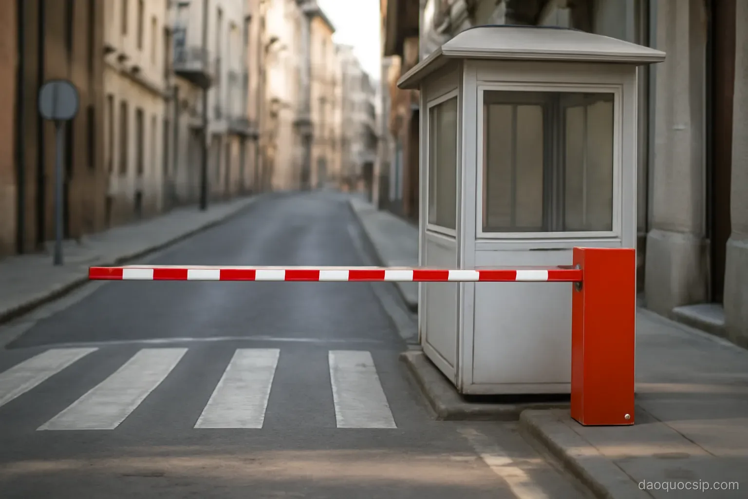 a pedestrian crossing point with a barrier and a small checkpoint booth on a narrow street
